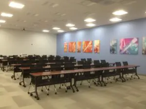 A room with many tables and chairs in it