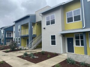 A row of houses with yellow and blue trim.