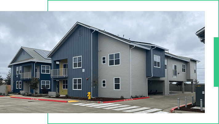 A large building with two levels and a garage.