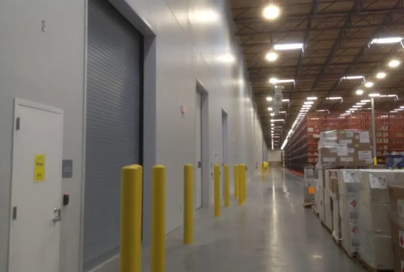 A warehouse with yellow posts and doors