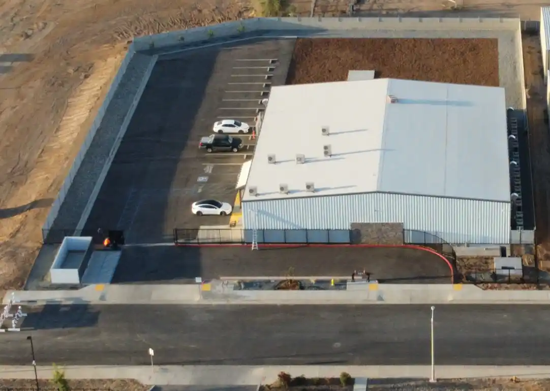 A large white building with cars parked in it.